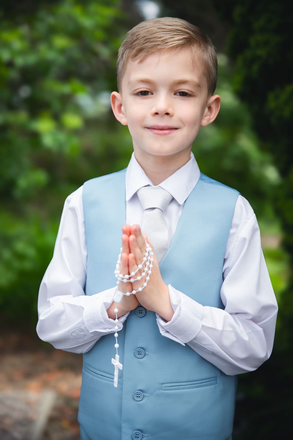 Boy in formal communion outfit outdoors