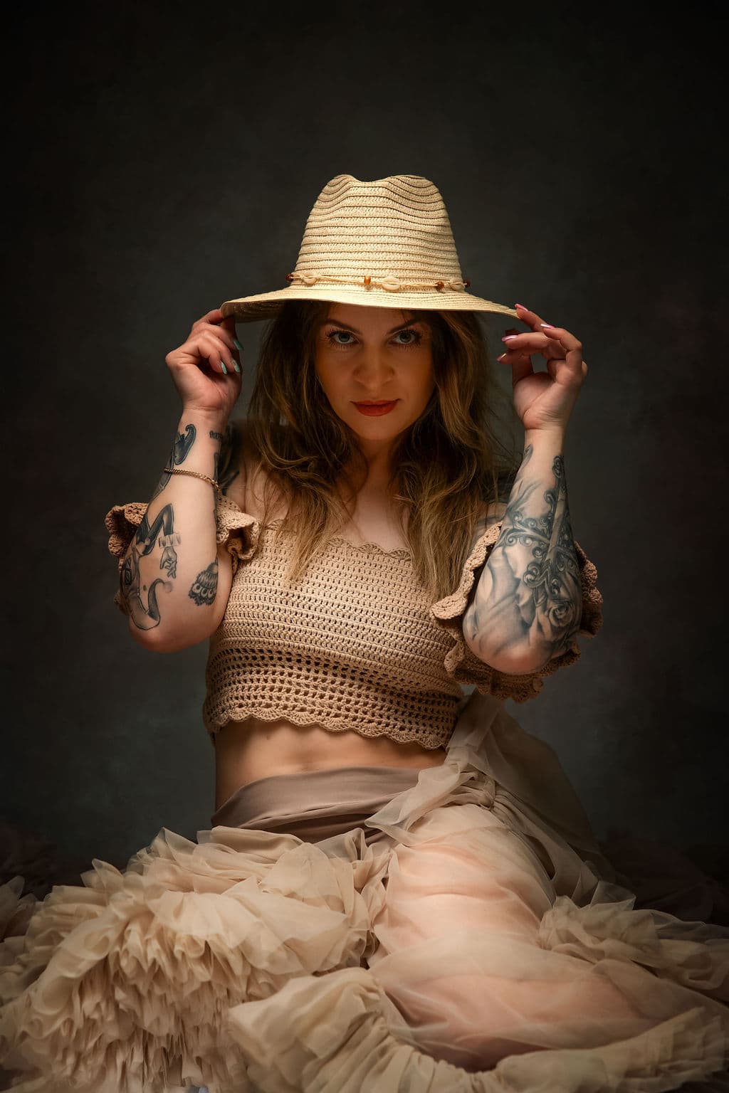 Glamour portrait with straw hat and tulle