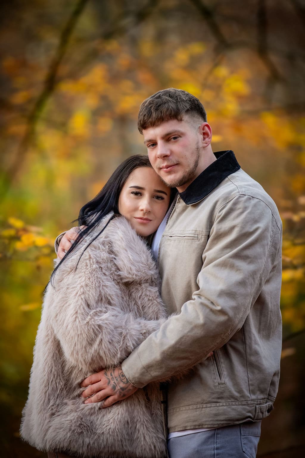 Couple embracing in golden foliage