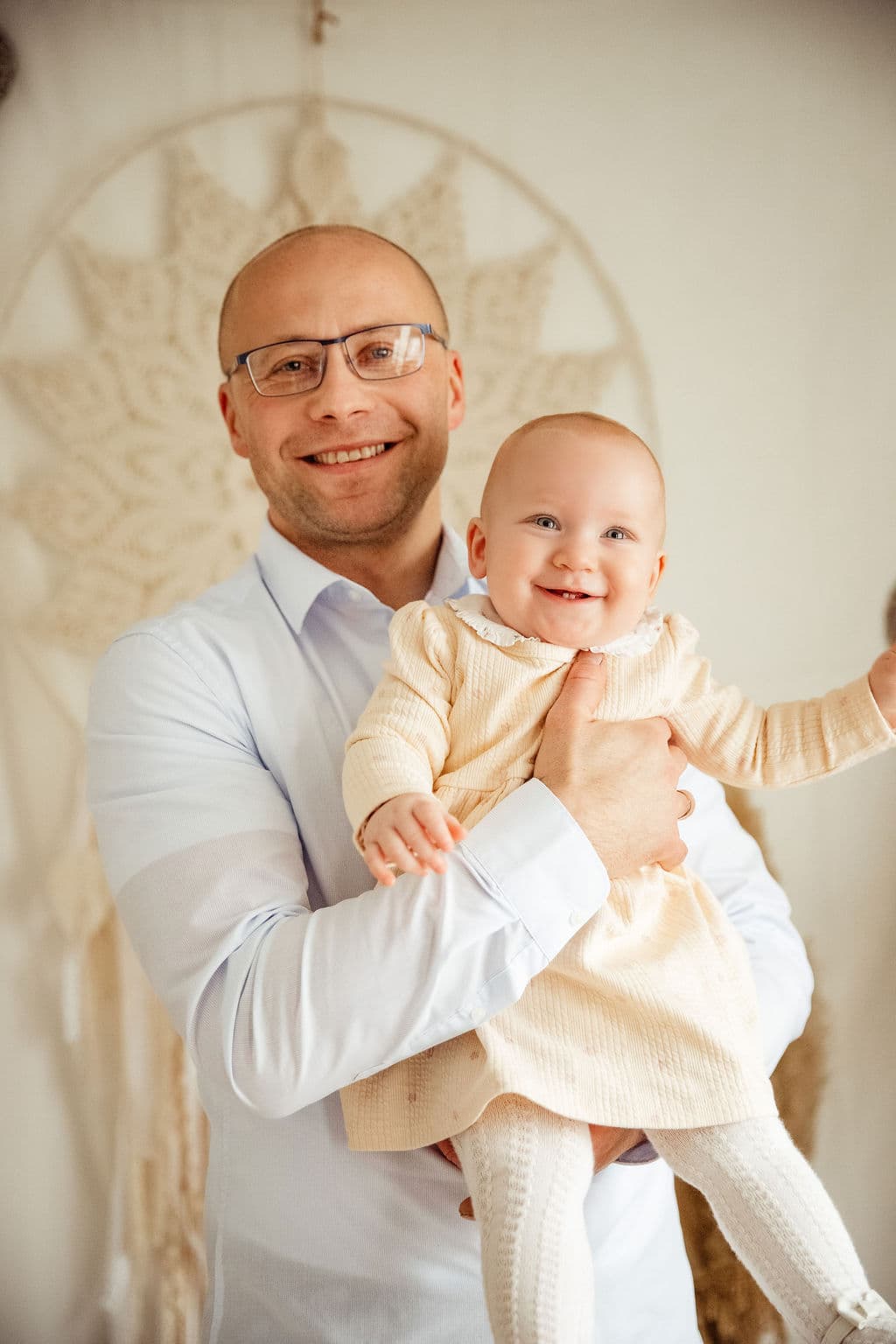 Father holding baby in studio